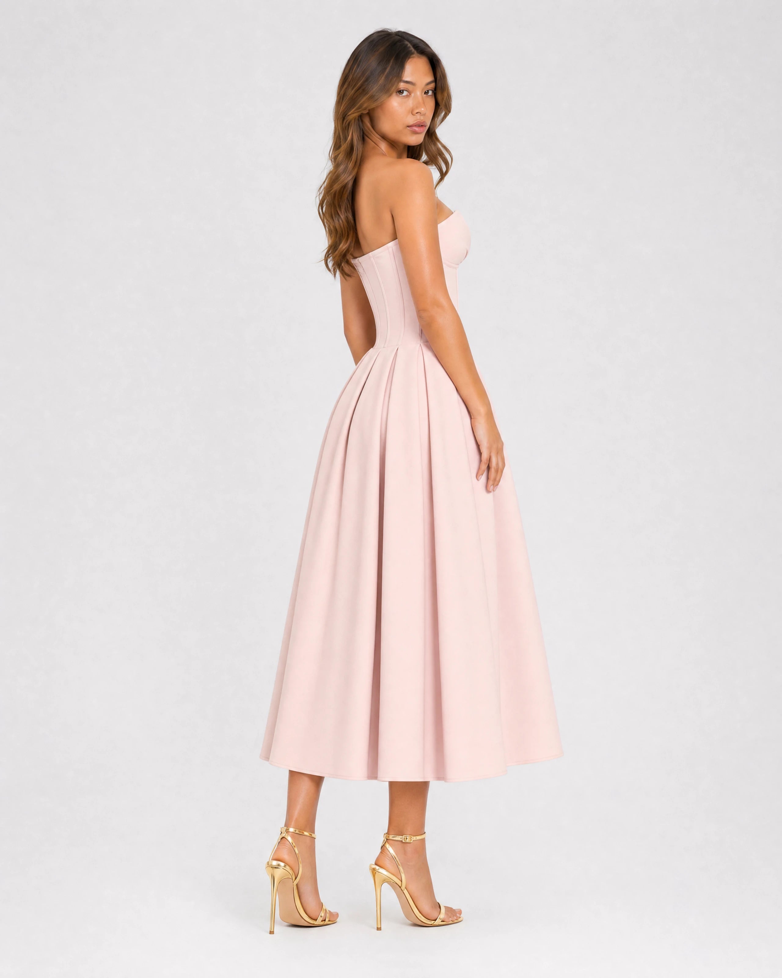 Adeline pink corset midi dress with full pleated skirt - three-quarter back view